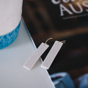 white textured gold rectangle earrings, Austin jewelry, porcelain wearable art, social impact jewelry, ethical accessory