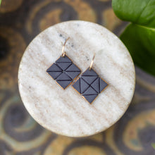 white and black square tile studs