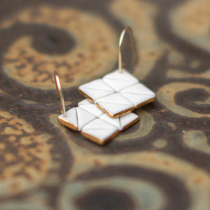 white and black square tile studs