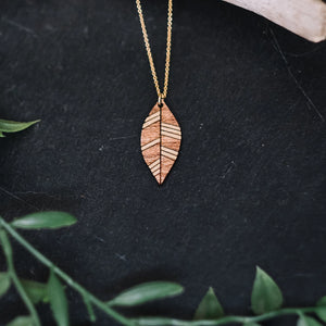 wood leaf necklace with gold accent, gilded wooden necklace, Austin jewelry, artisan wood wearable art, social impact jewelry, ethical accessory
