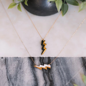lightning bolt necklace with gold accent, gold filigree jewelry, white and gold, black and gold, Austin jewelry, porcelain wearable art, social impact jewelry, ethical accessory