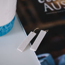 white textured gold rectangle earrings, Austin jewelry, porcelain wearable art, social impact jewelry, ethical accessory