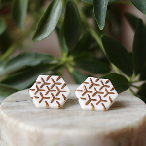 white and gold hexagon studs