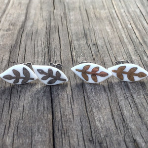 small white porcelain leaf studs with gold or white-gold design, Austin jewelry, social impact jewelry, ethical accessory