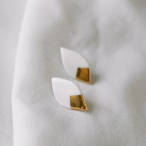 white and gold leaf stud earrings, gold filigree jewelry, Austin jewelry, porcelain wearable art, social impact jewelry, ethical accessory