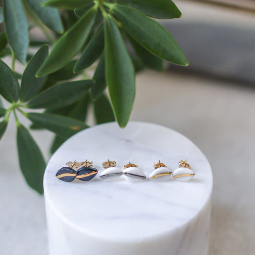 tiny leaf studs with gold accent